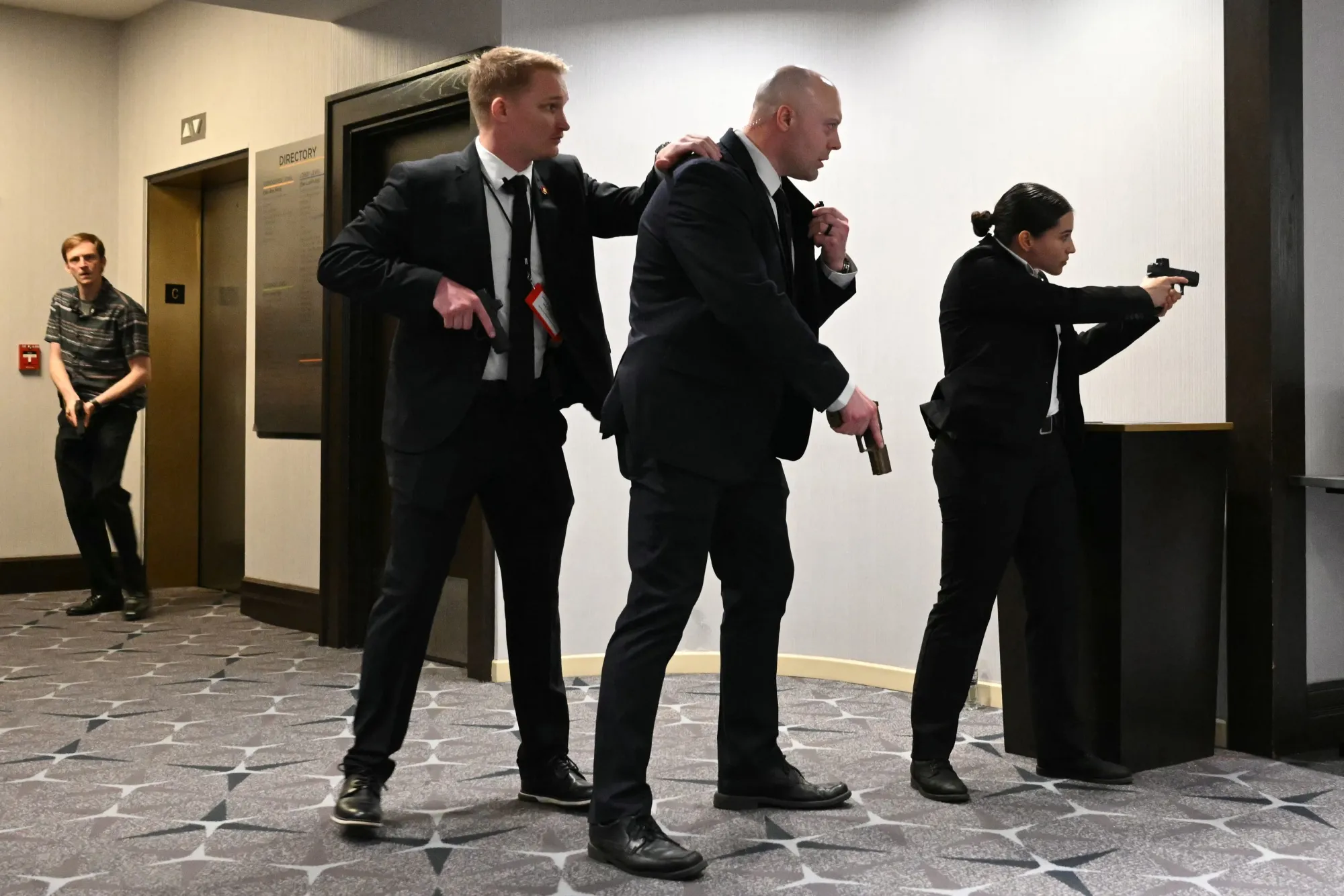 Agents draw their guns after loud bangs were heard during the White House Correspondents' dinner at the Washington Hilton in Washington on April 25.