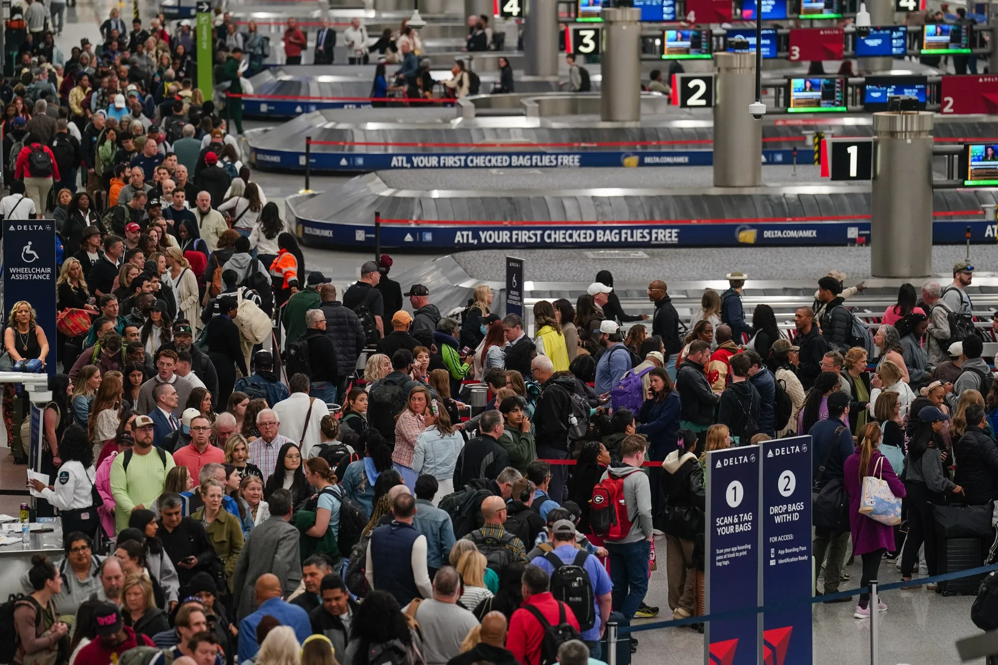 Travelers wait in line at a security checkpoint at Hartsfield-Jackson Atlanta International Airport on March 20.