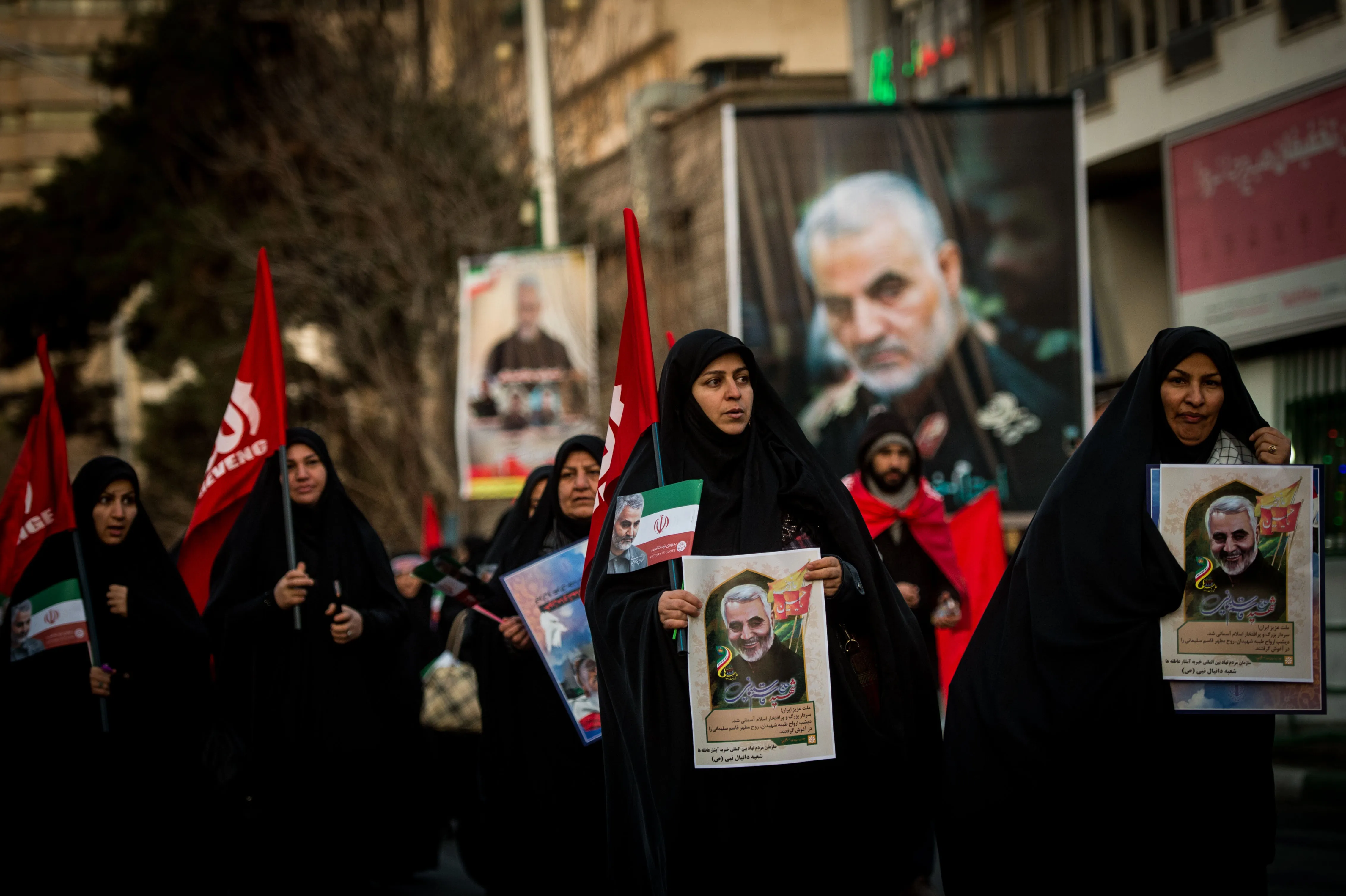 Mourners carry images of General&nbsp;Qassem Soleimani during his funeral ceremony in Tehran on Jan. 6.