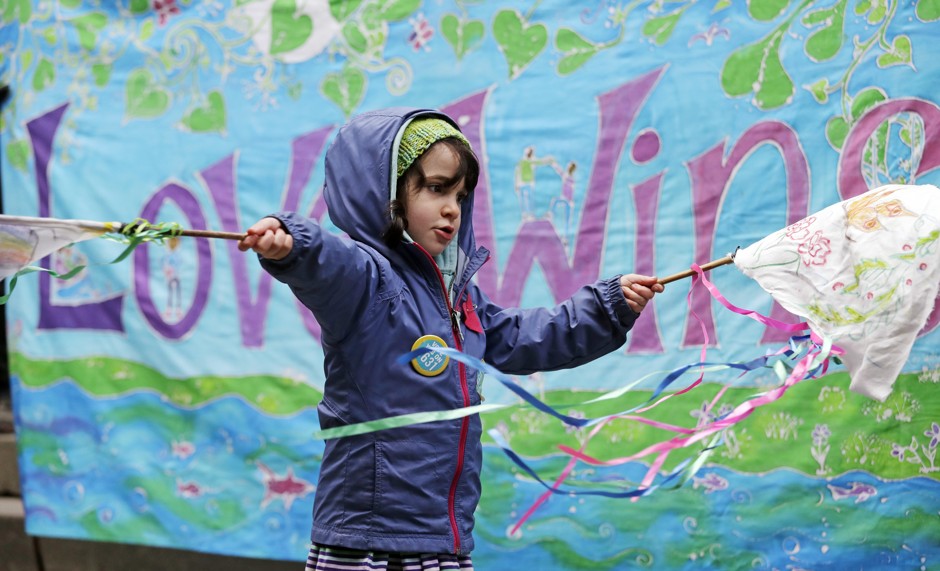A child waves home-made flags during a rally by youth activists and others in support of a high-profile climate change lawsuit in Seattle..