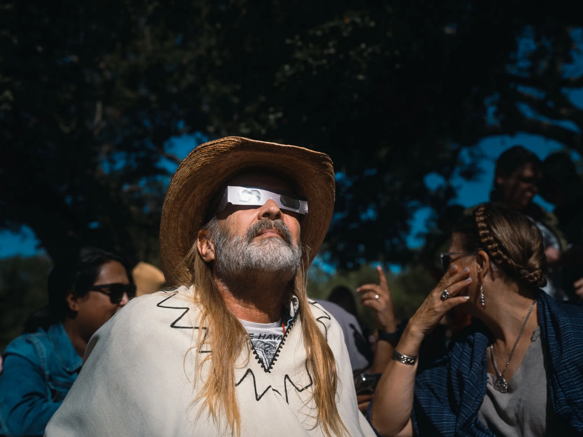 A spectator wears solar viewing glasses during a “ring of fire” solar eclipse in Driftwood, Texas, on Oct. 14, 2023.