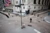 A pedestrian wearing a protective mask walks along Wall Street in front of the New York Stock Exchange (NYSE) in New York, U.S., on Monday, March 30, 2020. Roughly 37,500 people have tested positive for the coronavirus in New York City, officials said on Monday, up about 3,700 from a day earlier.