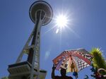 A balloon seller bakes in the Seattle sun