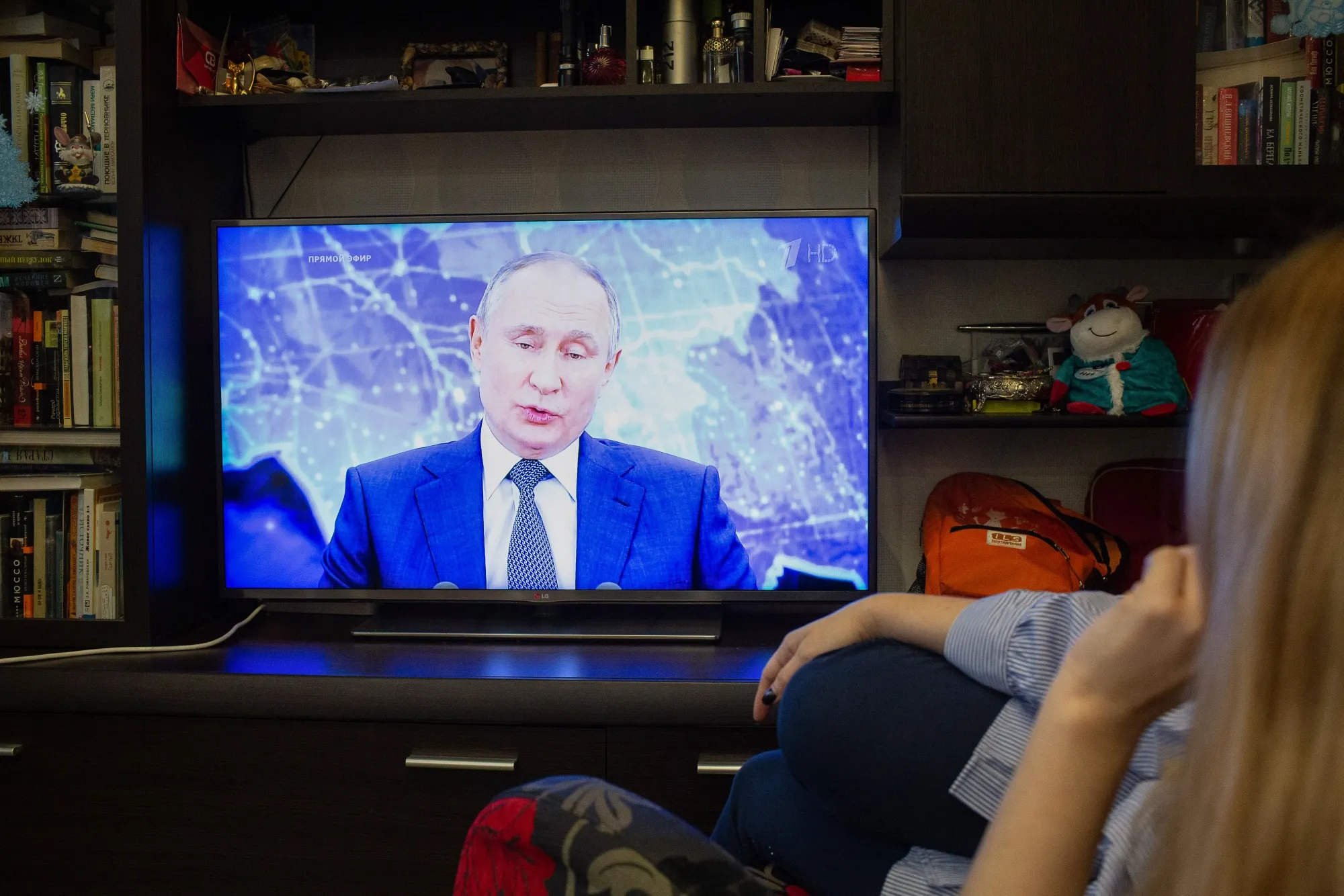 A resident watches&nbsp;Vladimir Putin delivering his annual address.&nbsp;