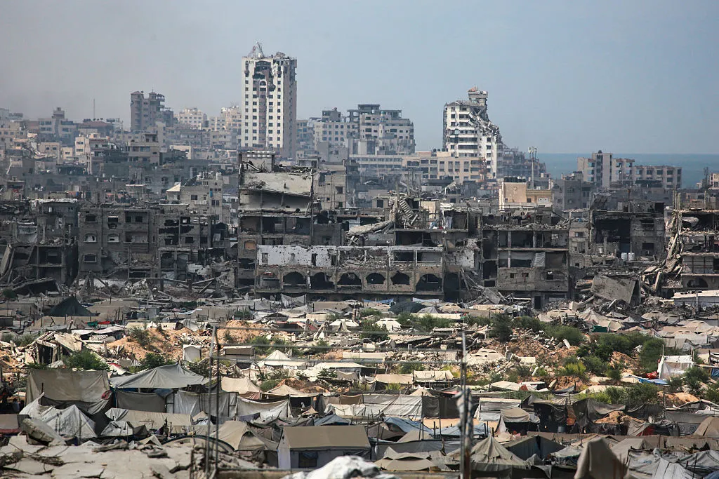 Buildings destroyed in Israeli strikes surround makeshift shelters in Gaza City, on Aug.&nbsp;8.