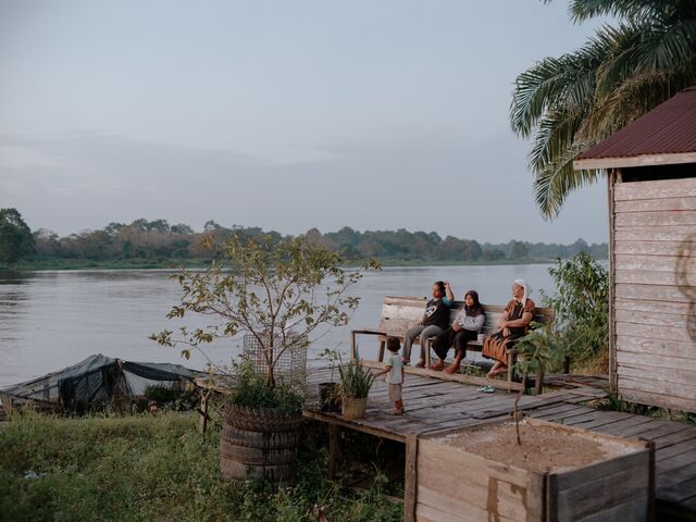 Locals sitting on the banks of the Seruyan River at dusk. Job losses at Rimba Raya have meant difficult choices for former workers.