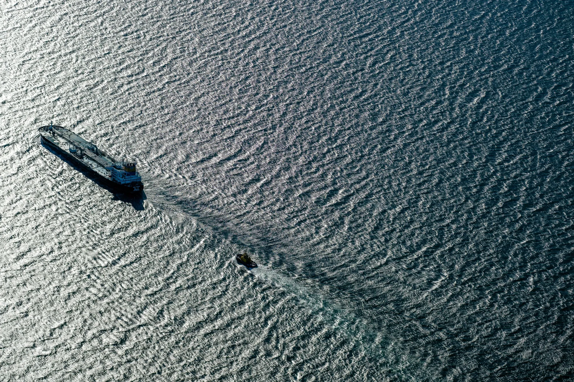 An oil tanker is escorted by a tugboat on the Strait of Juan de Fuca between Washington State and British Columbia, Canada.
