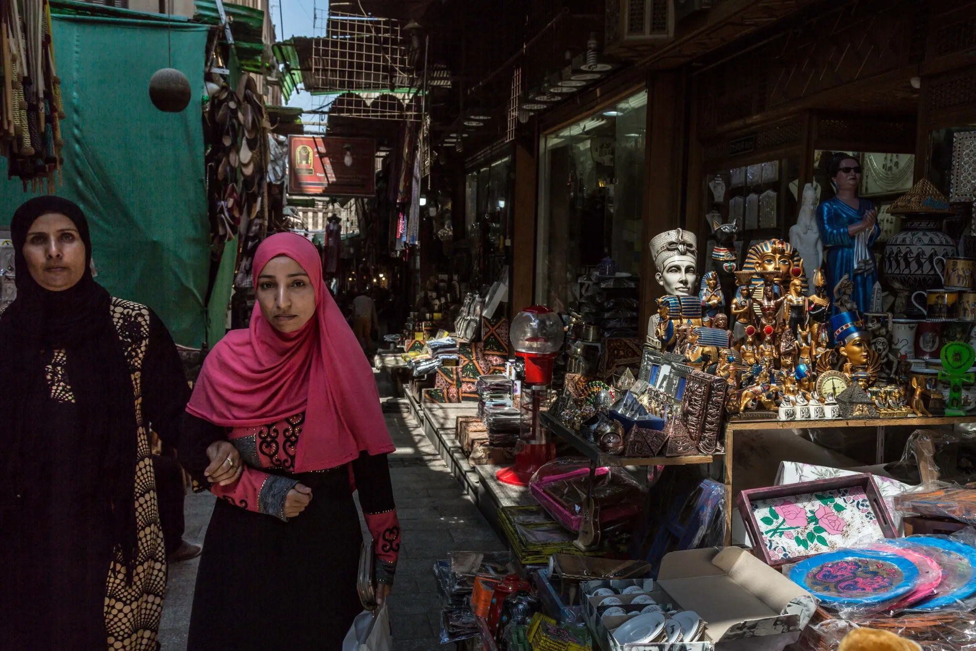 Pedestrians pass by market stalls in Cairo