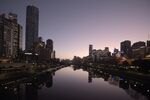 Buildings' lights are reflected in the Yarra River in Melbourne, Australia on Thursday, July 30, 2020. There are mounting concerns that the stay-at-home order in Melbourne, begun three weeks ago, will need to be extended, inflicting further damage on the economy. Photographer: Carla Gottgens/Bloomberg