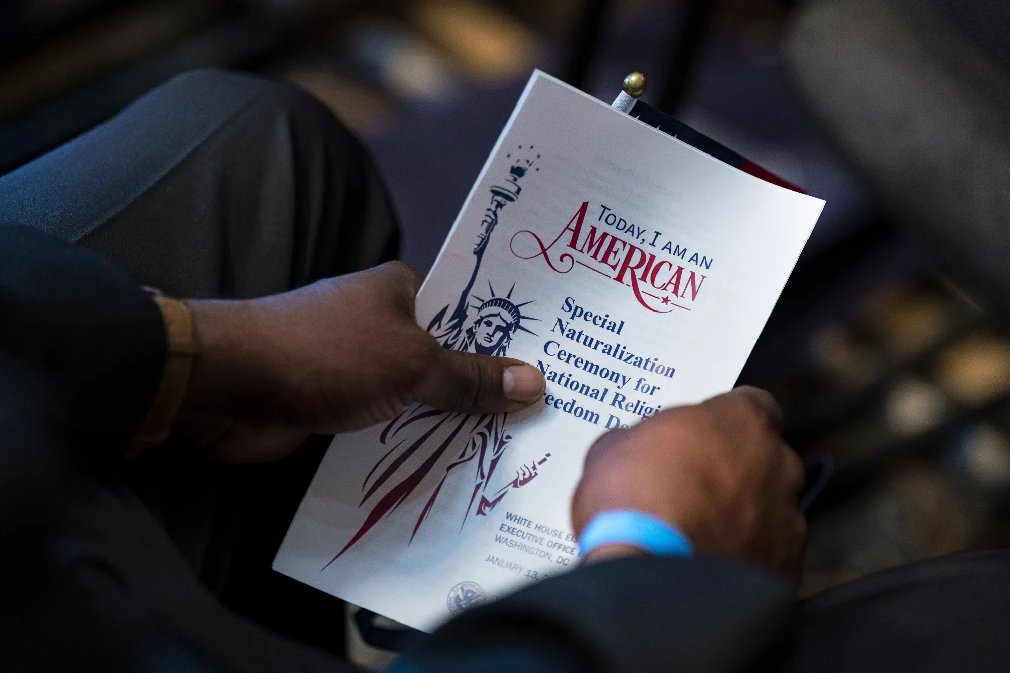 A candidate holds a program after taking the Oath of Allegiance to become a US citizen during a naturalization ceremony&nbsp;in Washington, DC.