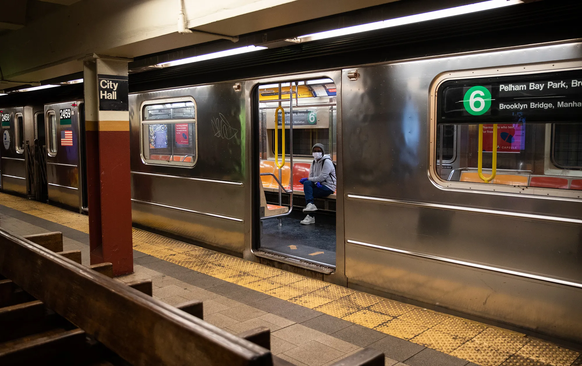 A commuter wearing a protective mask&nbsp;sits inside a train at a subway station in New York on&nbsp;April 1.&nbsp;