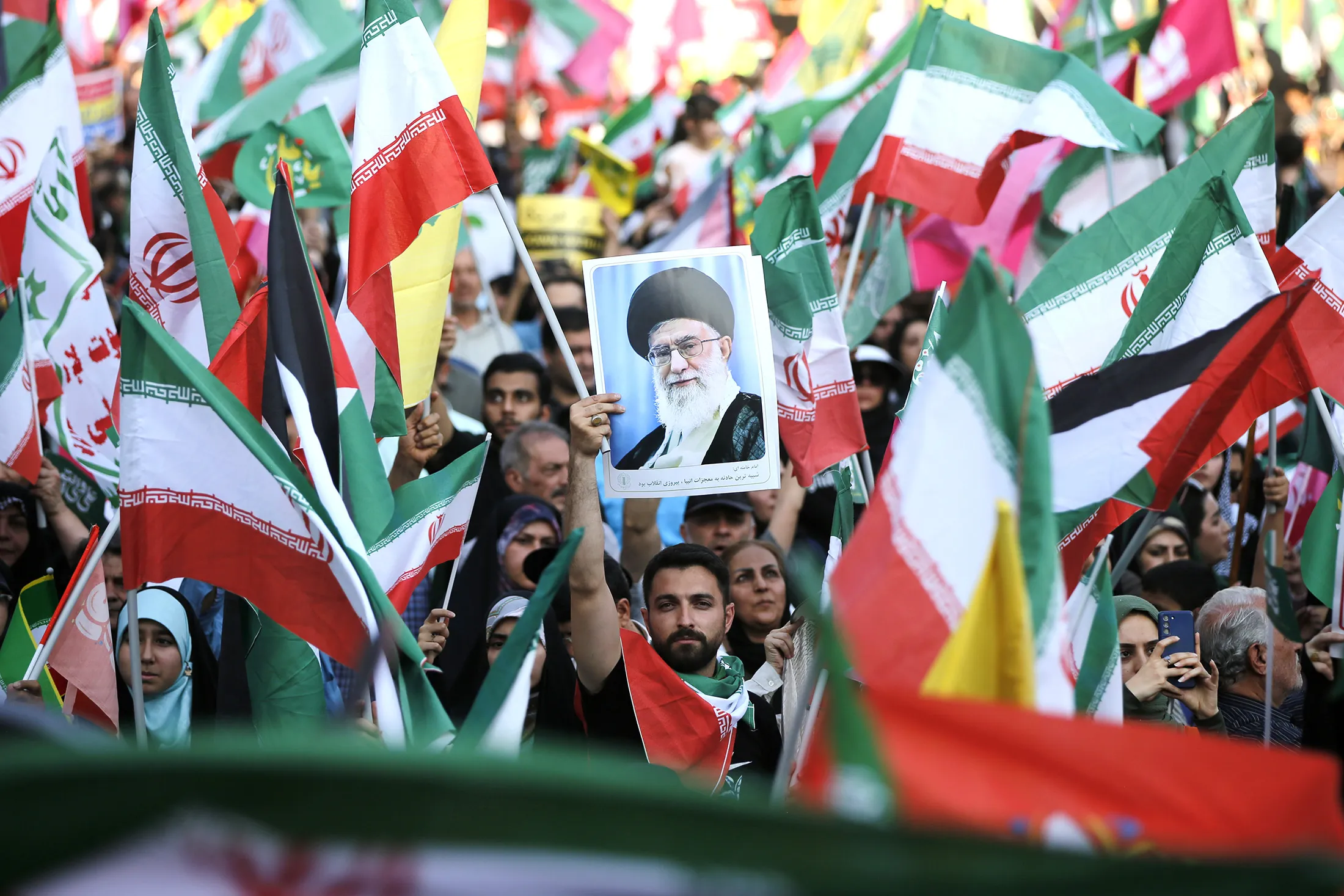 A demonstrator holds an image of&nbsp;Supreme Leader Ayatollah Ali Khamenei during an&nbsp;anti-Israel and anti-US&nbsp;protest in Tehran on June 14.
