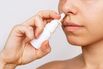 Cropped shot of a young caucasian woman using nasal spray for a runny nose and congestion