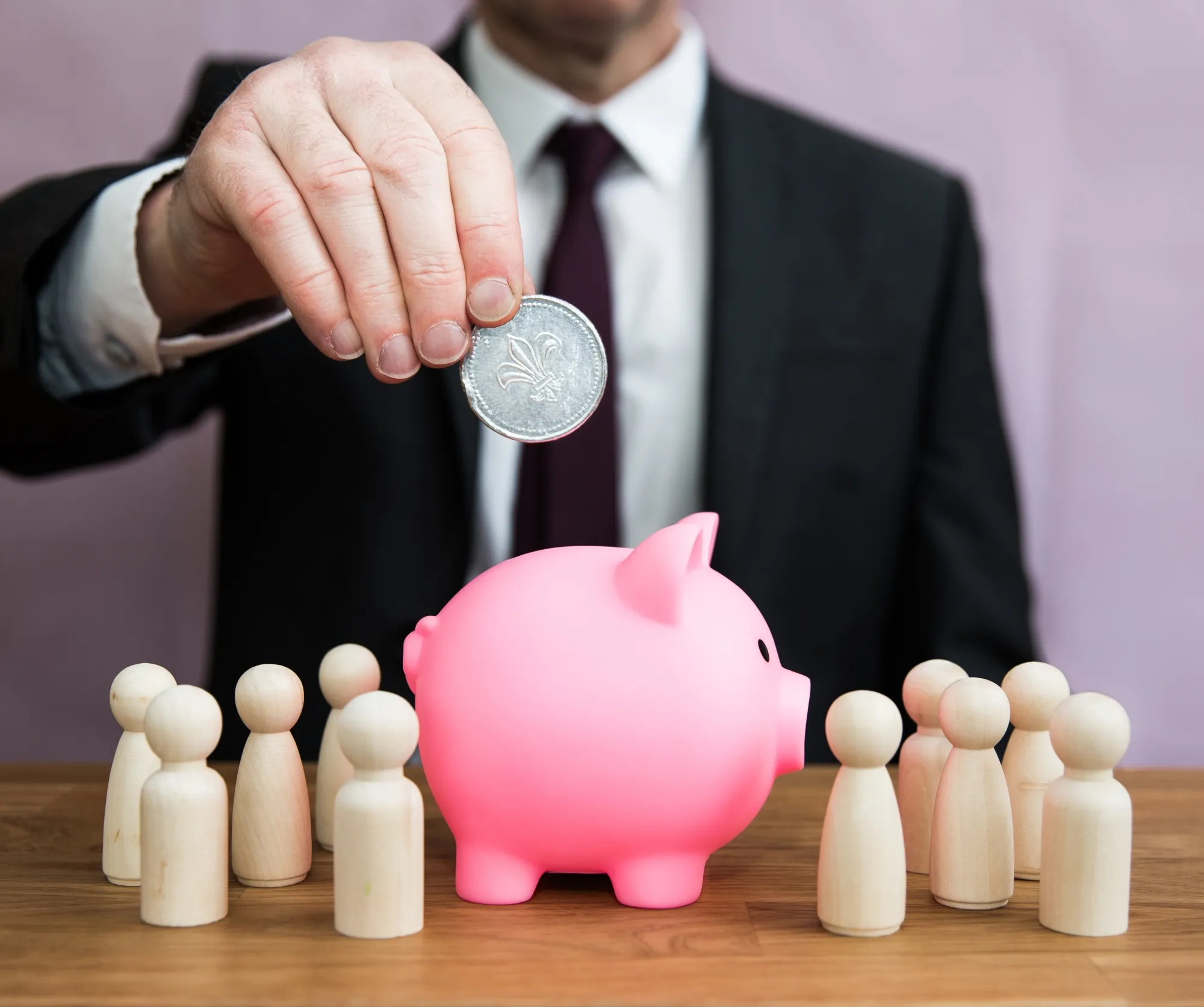 A Business Concept Of A Man Paying Into An Employee Salary, Pension, Tax, Bonus Or Incentive Scheme