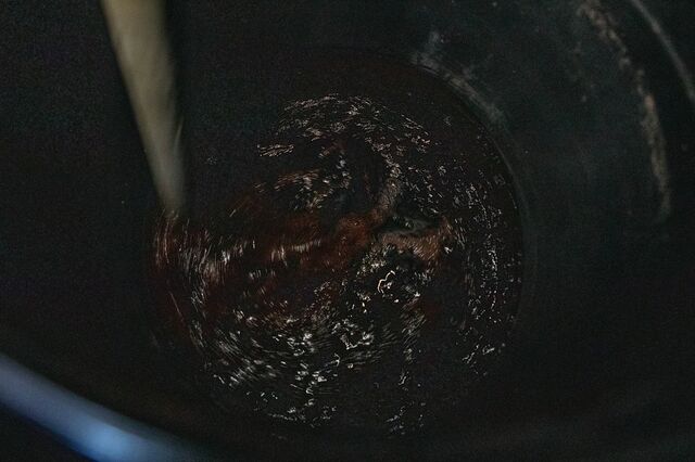 A dark solution to mix with organic trash before it is blended together.