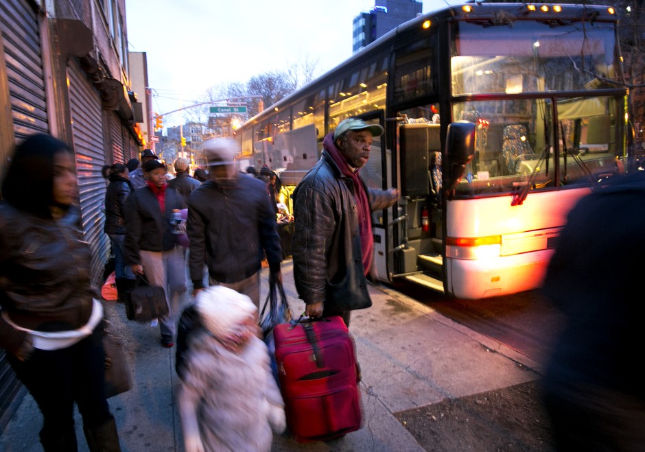 Passengers arrive in New York's Chinatown on an intercity bus during Thanksgiving travel in 2013.
