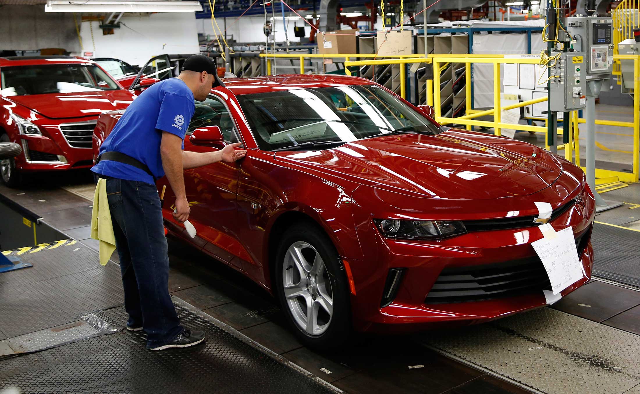 An employee works on a 2016 Chevrolet Camaro on the production line at the General Motors Co. (GM) Lansing Grand River Assembly plant in Lansing, Michigan, on Oct. 26.
