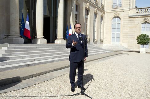 President Francois Hollande speaks to reporters today