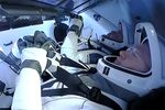 Doug Hurley, left, and Bob Behnken sit inside the Dragon crew capsule on Sunday.