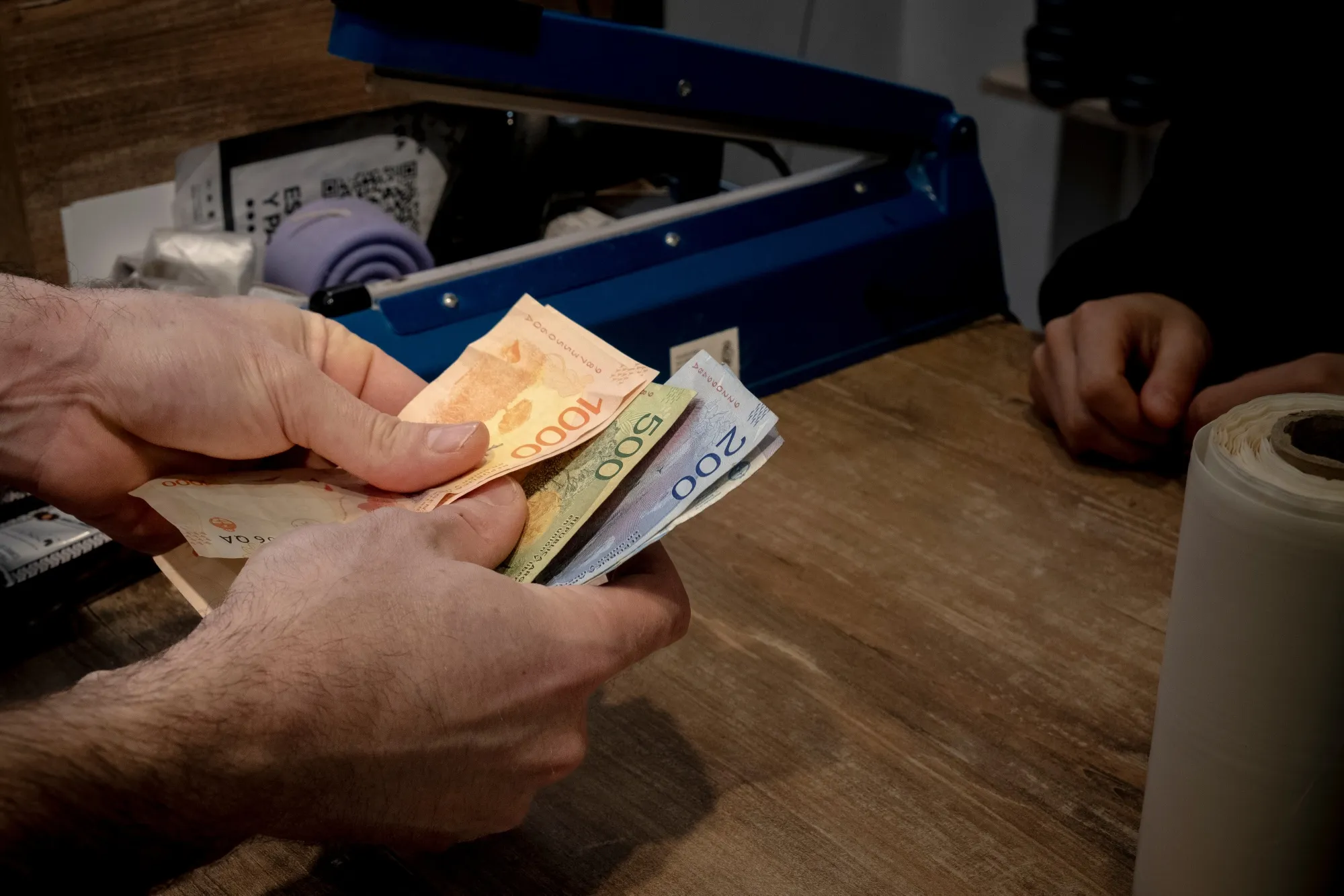 A customer pays with Argentine pesos in a shop in Buenos Aires, Argentina.