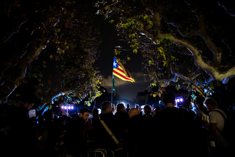 People attend a gathering in support of the members of the dismissed Catalan cabinet regional Parliament in Barcelona.