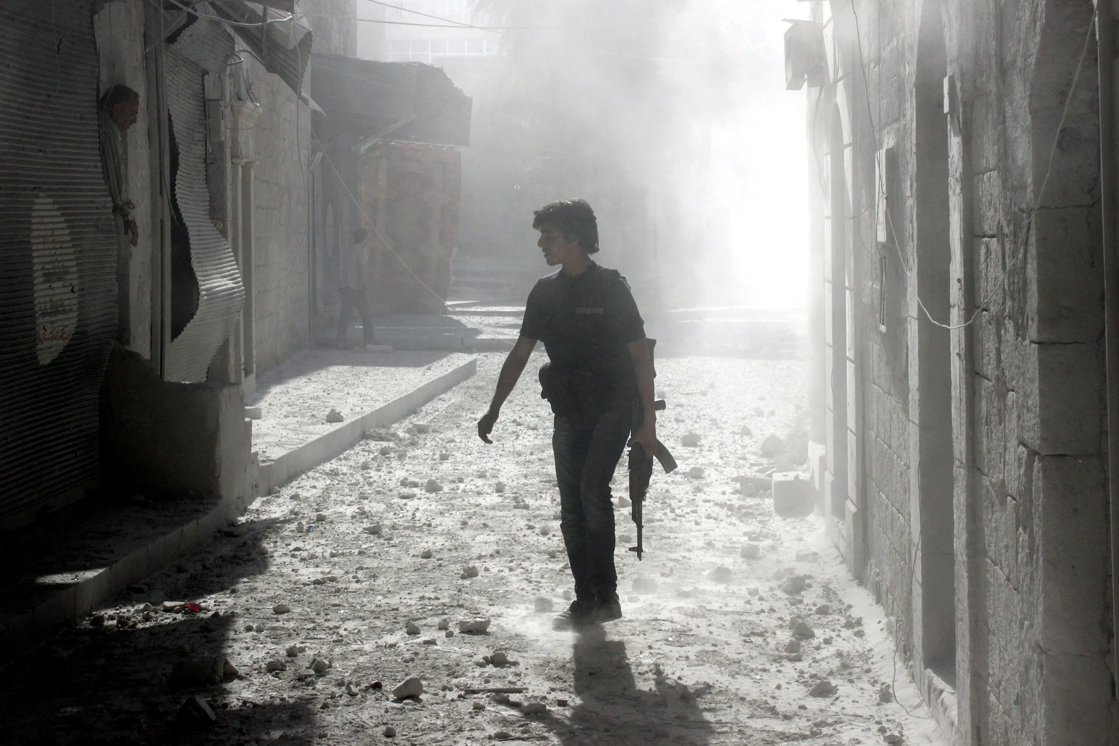 A Syrian rebel walks the streets of Aleppo, Syria.
