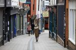 Pedestrians pass retail outlets on Lower Goat Lane in Norwich, U.K., on Tuesday, June 9, 2020. 