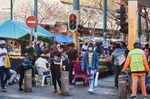 Shoppers walk through a market in the central business district (CBD) of Pretoria, South Africa.