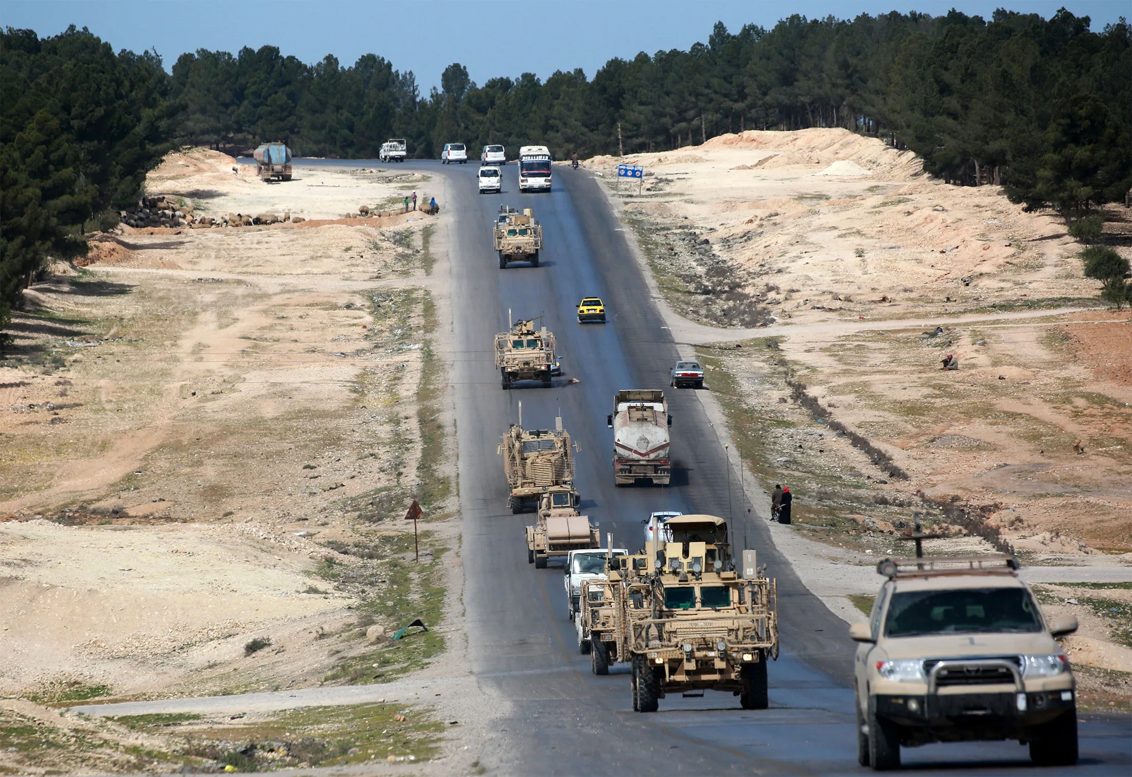 Vehicles of&nbsp;US-backed coalition forces&nbsp;drive&nbsp;in the northern Syrian town of Manbij.