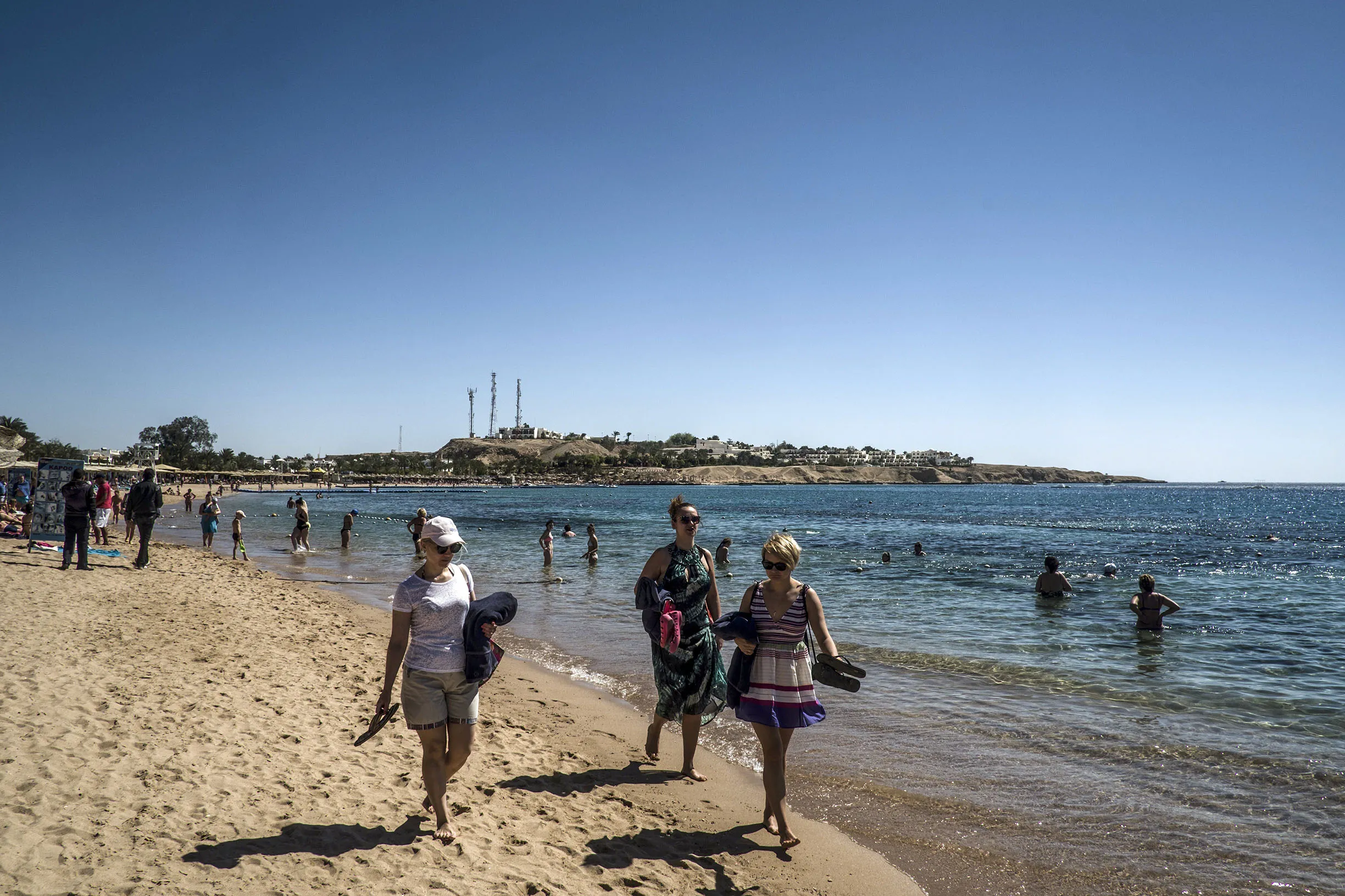 Tourists walk on the beach at a resort in Sharm el-Sheikh.&nbsp;