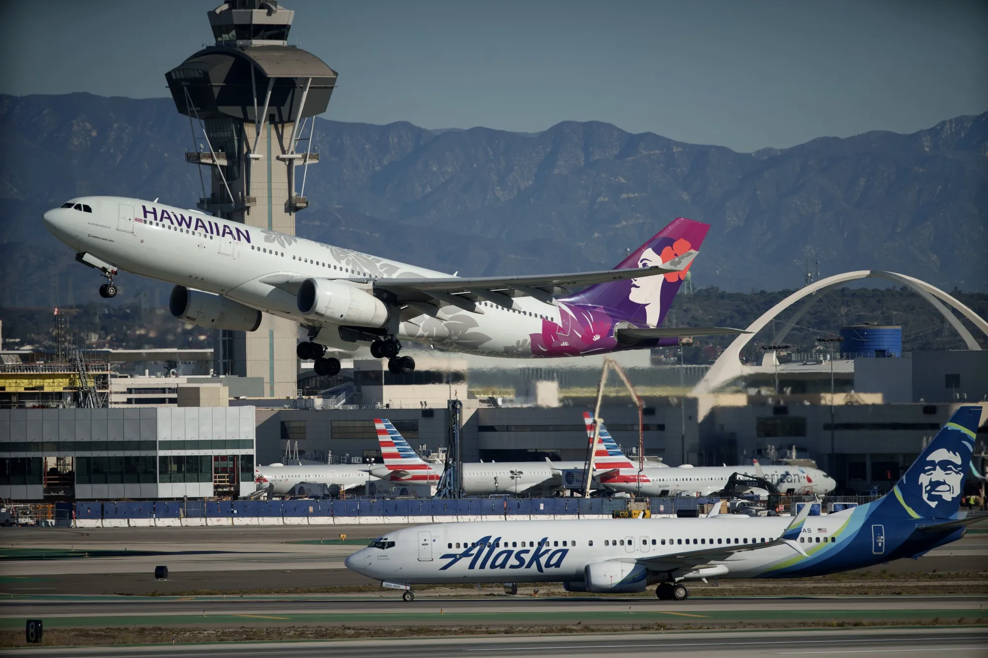 Hawaiian Airlines and Alaska Airlines passenger jets at LAX.