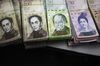 Bolivar notes separated for bank deposit are seen in the office of a bakery in Caracas, Venezuela, on Tuesday, Nov. 29, 2016. 