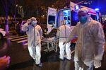Medical staff in protective clothing bring a patient at the Wuhan Red Cross Hospital on Jan. 25.