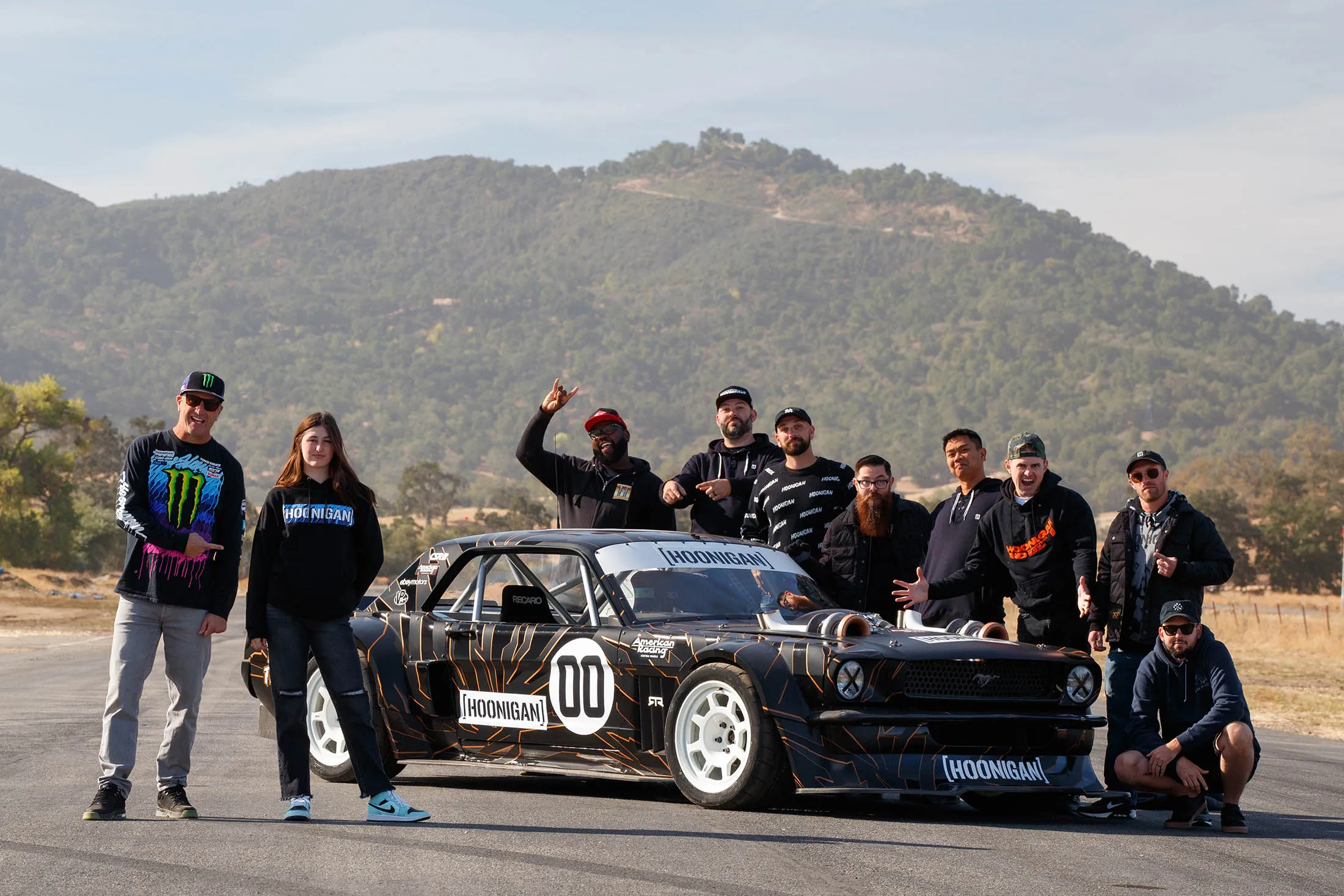 Ken and Lia Block (at&nbsp;left) stand with the Hoonicorn. The car has been updated with a roll cage, paddle shifters, and a full-halo seat to&nbsp;protect&nbsp;the driver in case of impact.&nbsp;