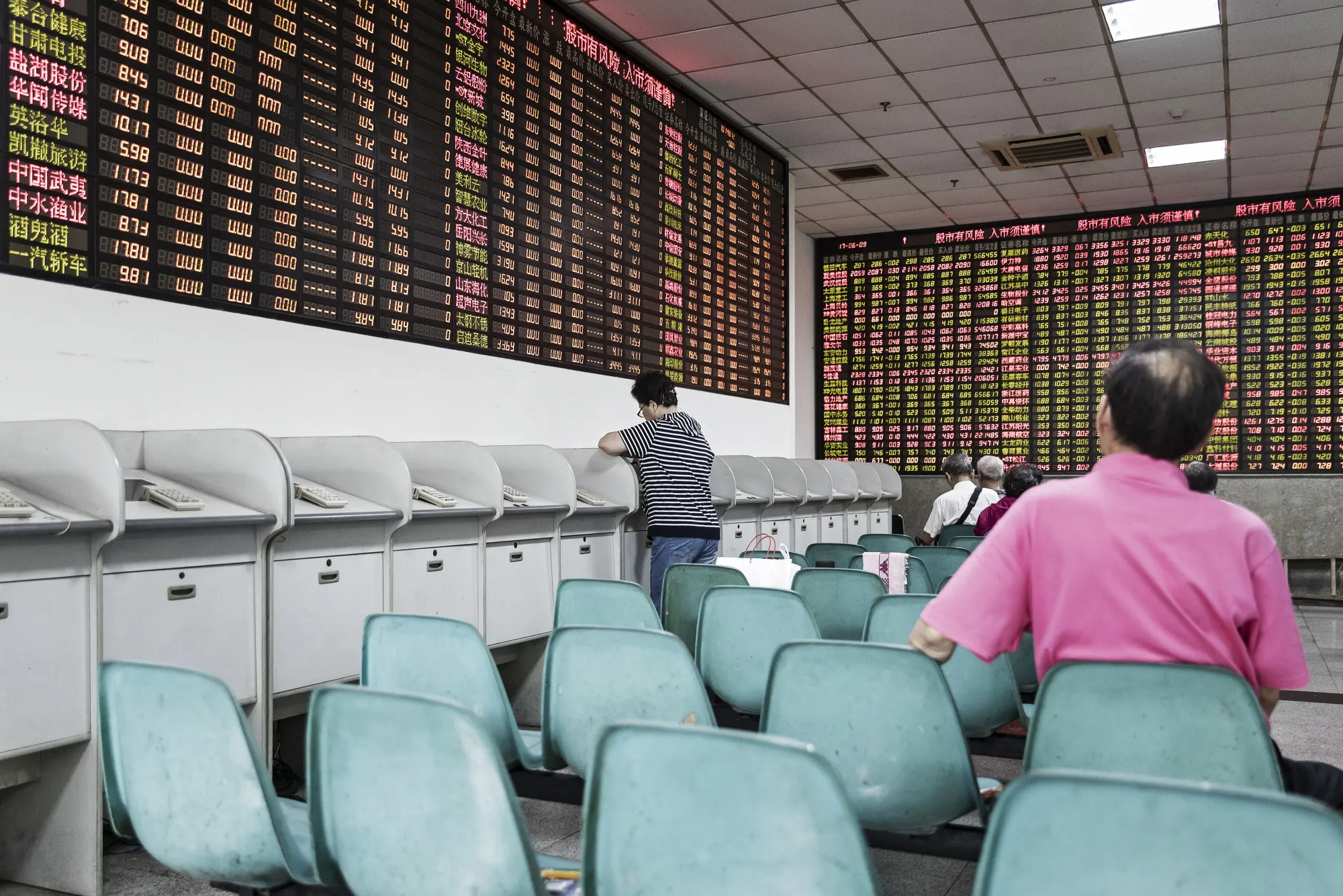 Investors Watch Stock Boards At A Security Firm