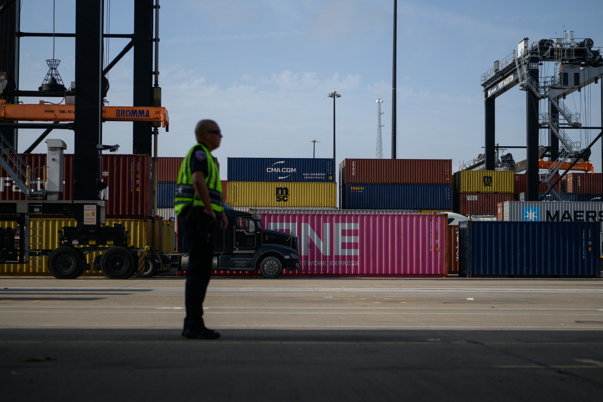 A worker at the Bayport Container Terminal at the port of Houston in Seabrook, Texas, US, on Thursday, May 22, 2025. US businesses are under mounting pressure to import goods while President Donald Trump's higher tariffs are on pause, and they're simultaneously navigating increasingly complex filing rules when their cargo crosses the border. Photographer: Callaghan O'Hare/Bloomberg