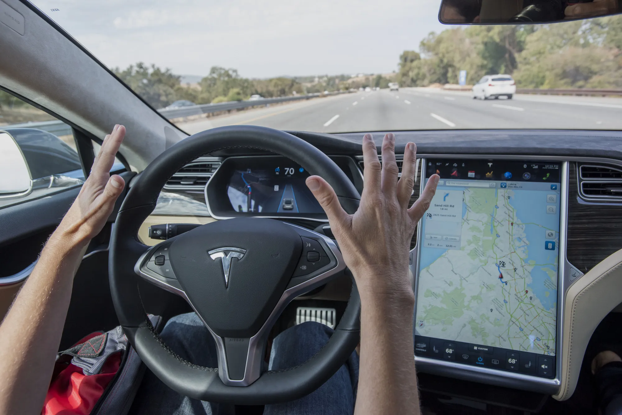 A person drives a Tesla Motors&nbsp;car equipped with Autopilot in Palo Alto, California.
