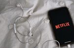 Netflix Inc. signage is displayed on an Apple Inc. iPhone