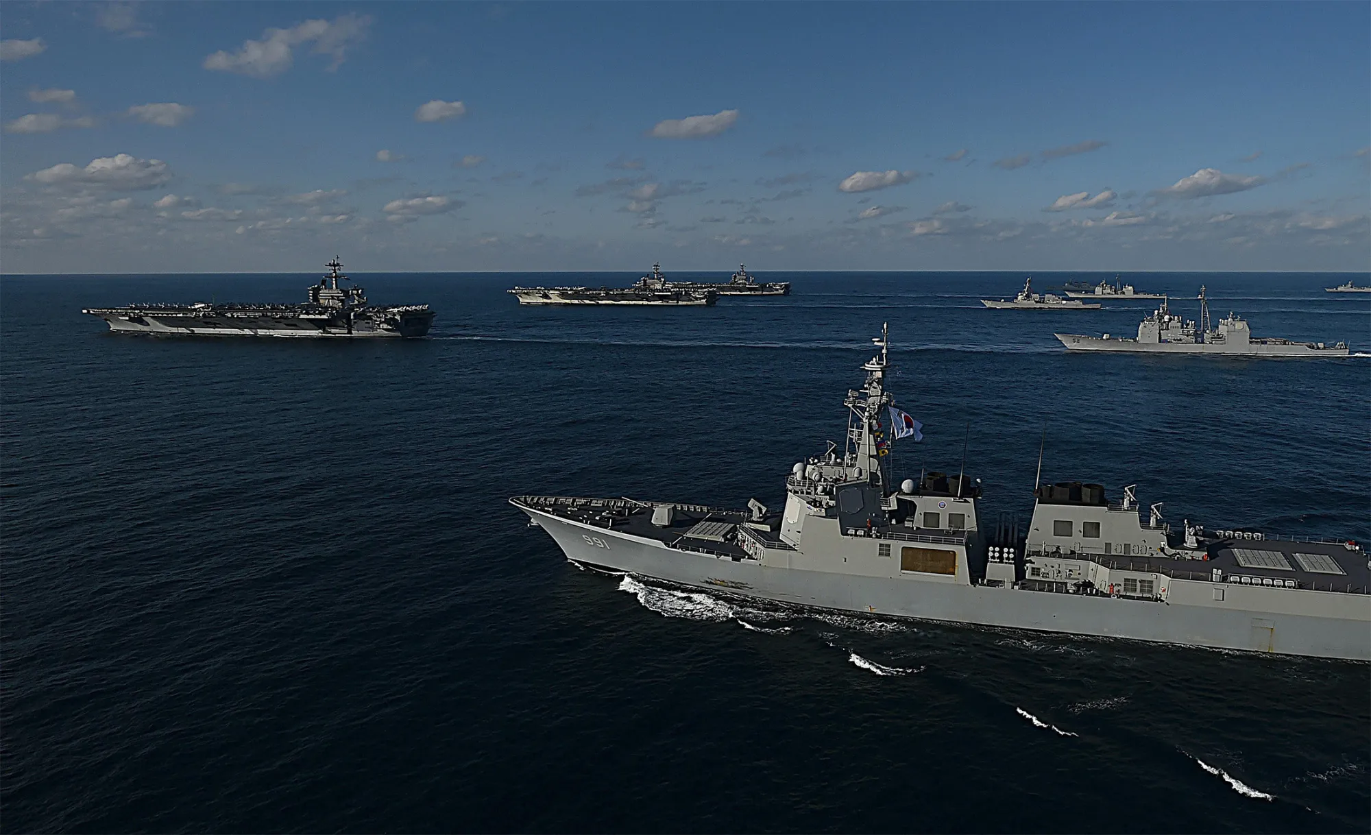 In this handout image released September 13 by South Korean Defense Ministry, USS Nimitz (3rd L), USS Ronald Reagan (2nd L) and USS Theodore Roosevelt (L) conducting operations with South Korea's destroyers during a joint naval drill on November 12, 2017 in East Sea, South Korea.&nbsp;