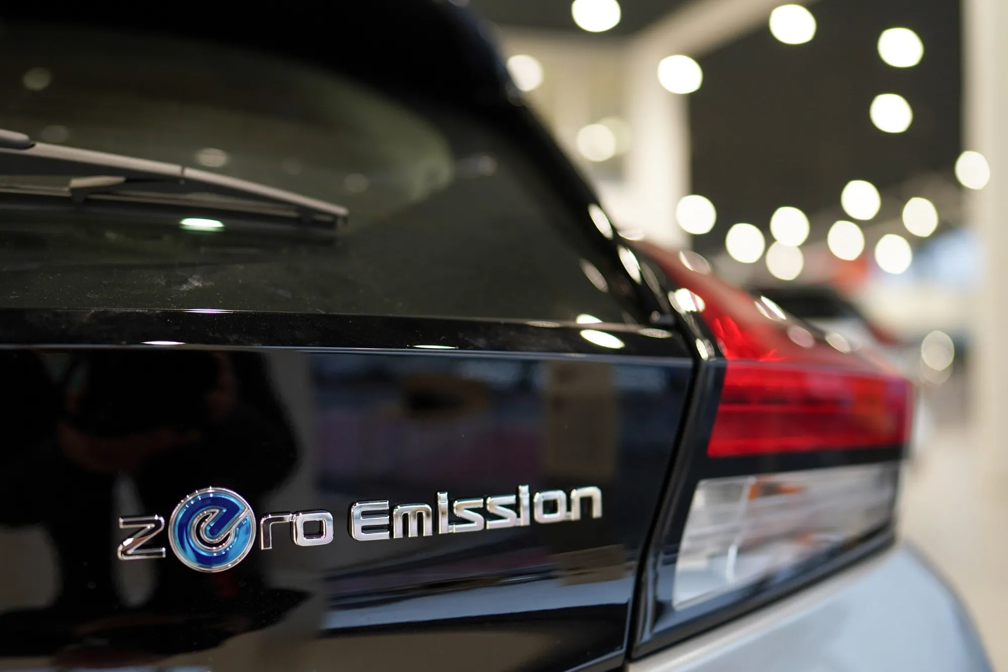 A Zero Emission badge on a Nissan Motor Co. Leaf electric automobile at a dealership in Sunderland, U.K.