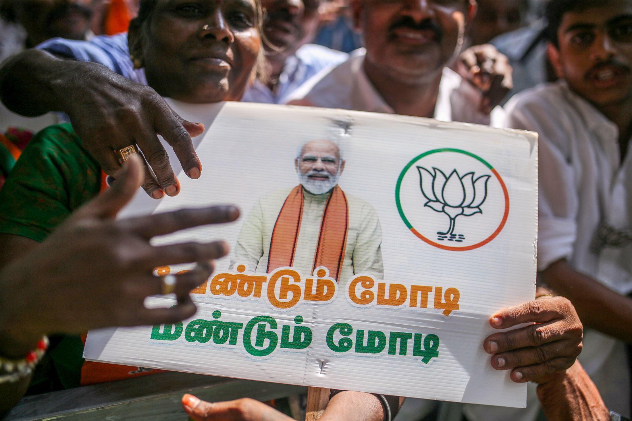 Supporters hold up a sign in Tamil at&nbsp;a&nbsp;campaign rally with Indian Prime Minister Narendra Modi in Coimbatore, Tamil Nadu on&nbsp;April 10.