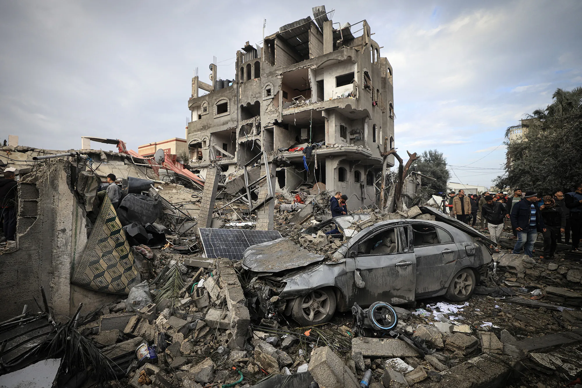 Residents inspect damage at the Al-Maghazi refugee camp after an overnight air strike.