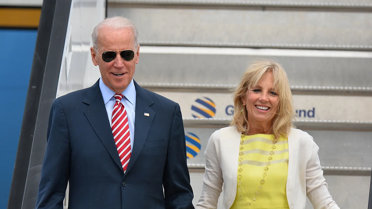 US Vice President Joe Biden (L) and his wife Jill Biden (R) walk down the gangway after landing atthe 'Henry Coanda' international Airport in Bucharest on May 20, 2014
