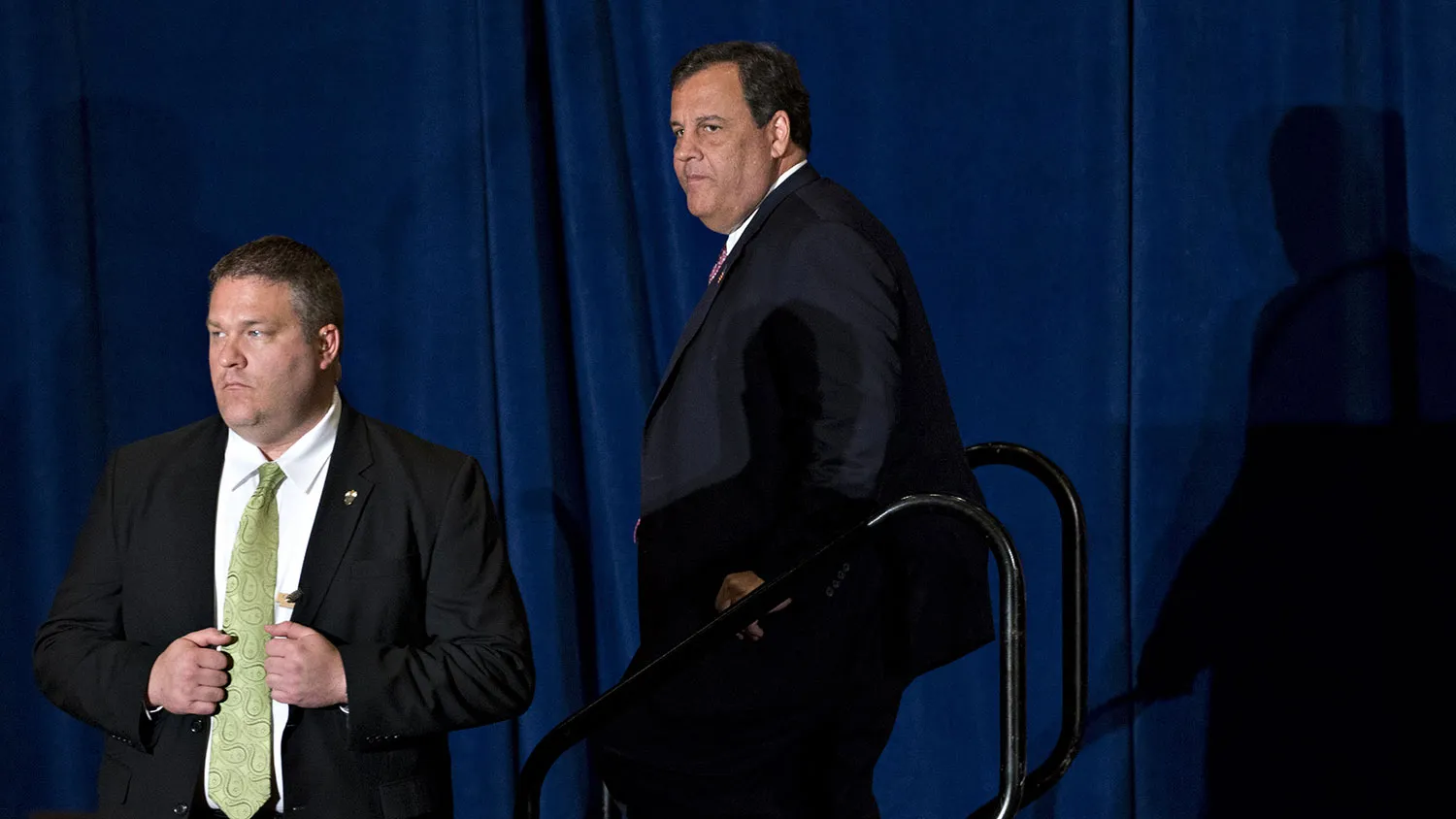 Chris Christie, governor of New Jersey, walks off stage next to a U.S. Secret Service officer after speaking during an event with Donald Trump in Virginia Beach, Virginia, on July 11, 2016.
