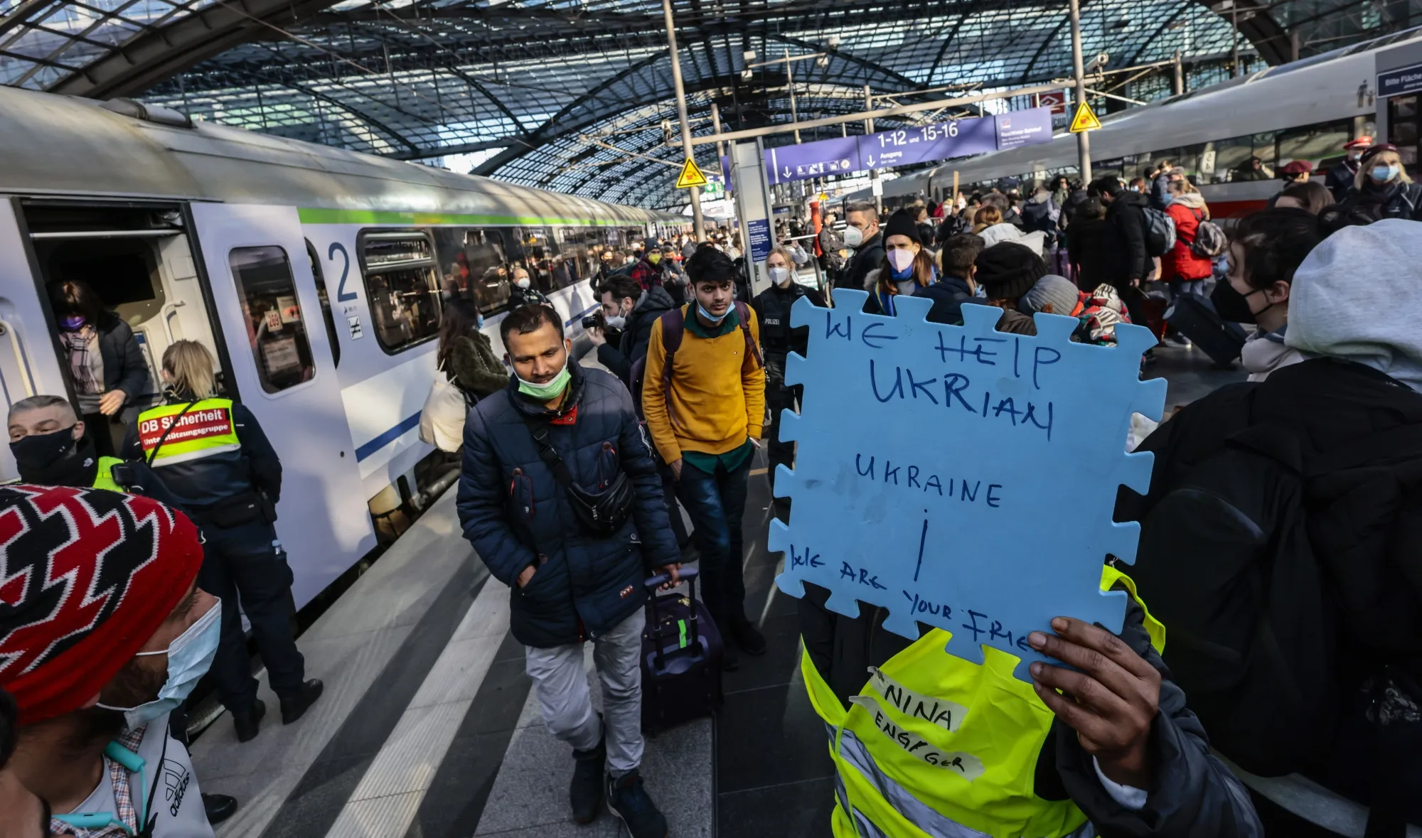 Volunteers wait to assist refugees from Ukraine arriving in Berlin in March 2022.