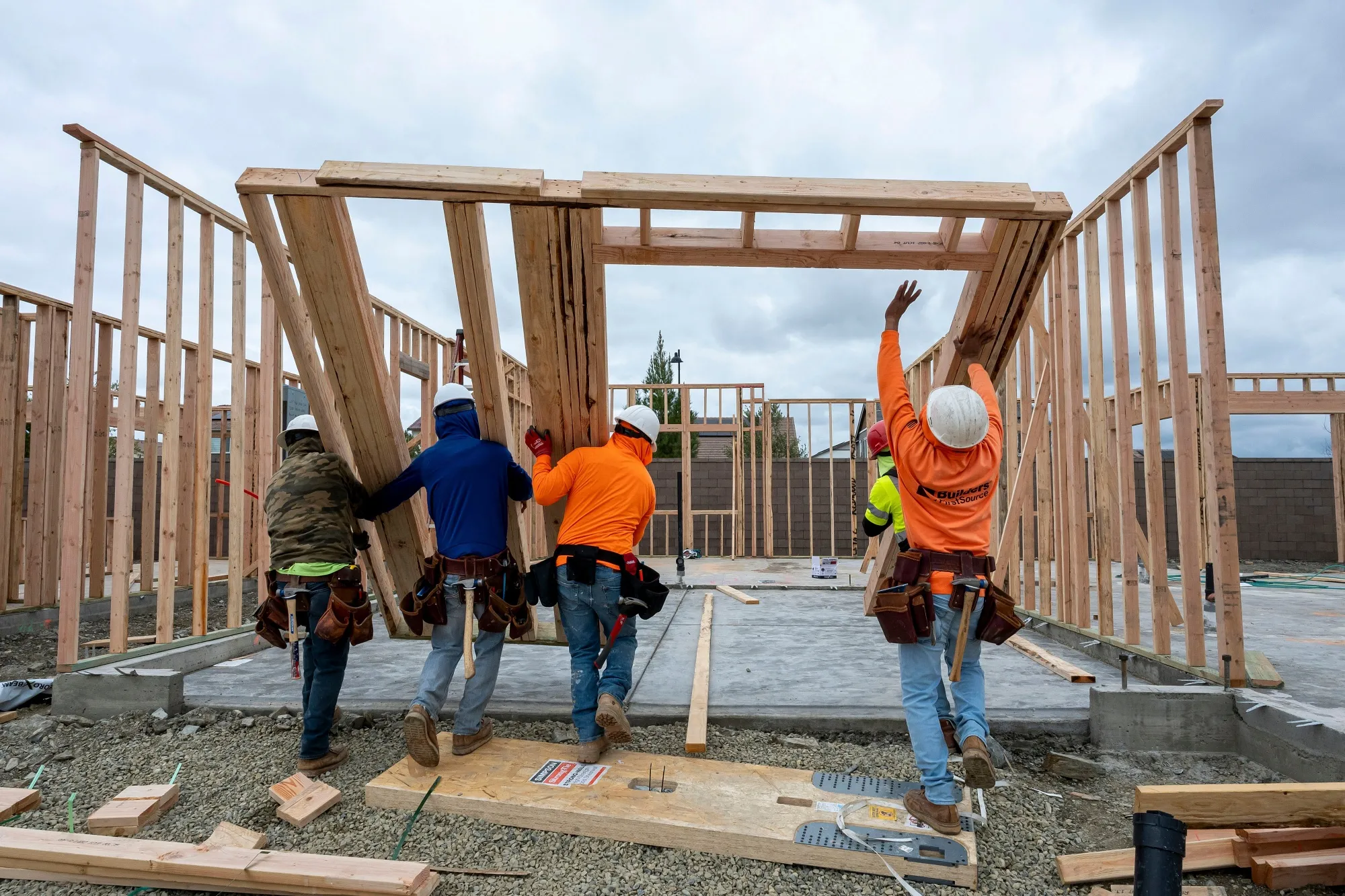 Construction workers raise a framed wall while&nbsp; building a home in Folsom, California.