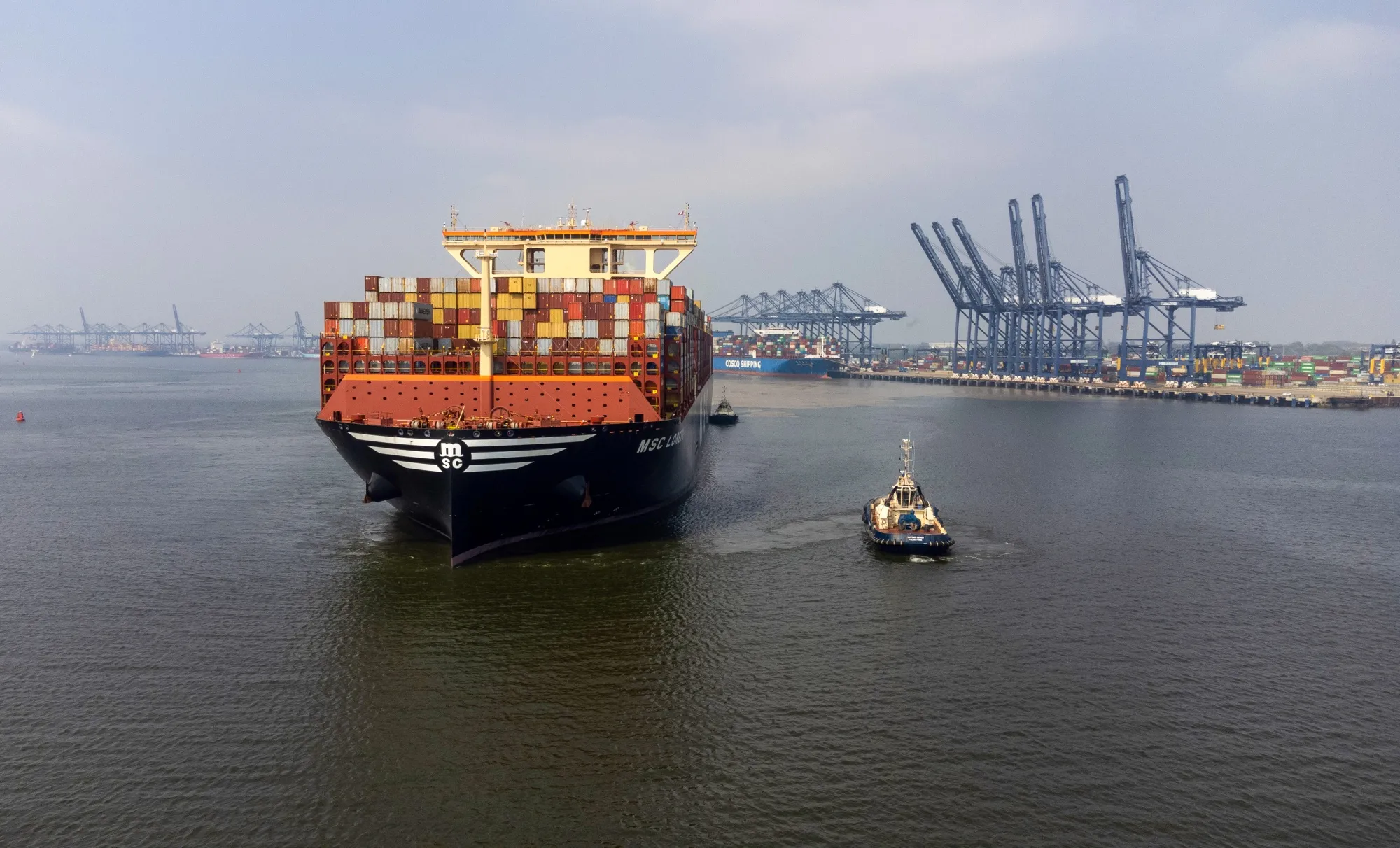 A tugboat assists a container ship as it&nbsp;leaves the Port of Felixstowe in Felixstowe, UK.&nbsp;