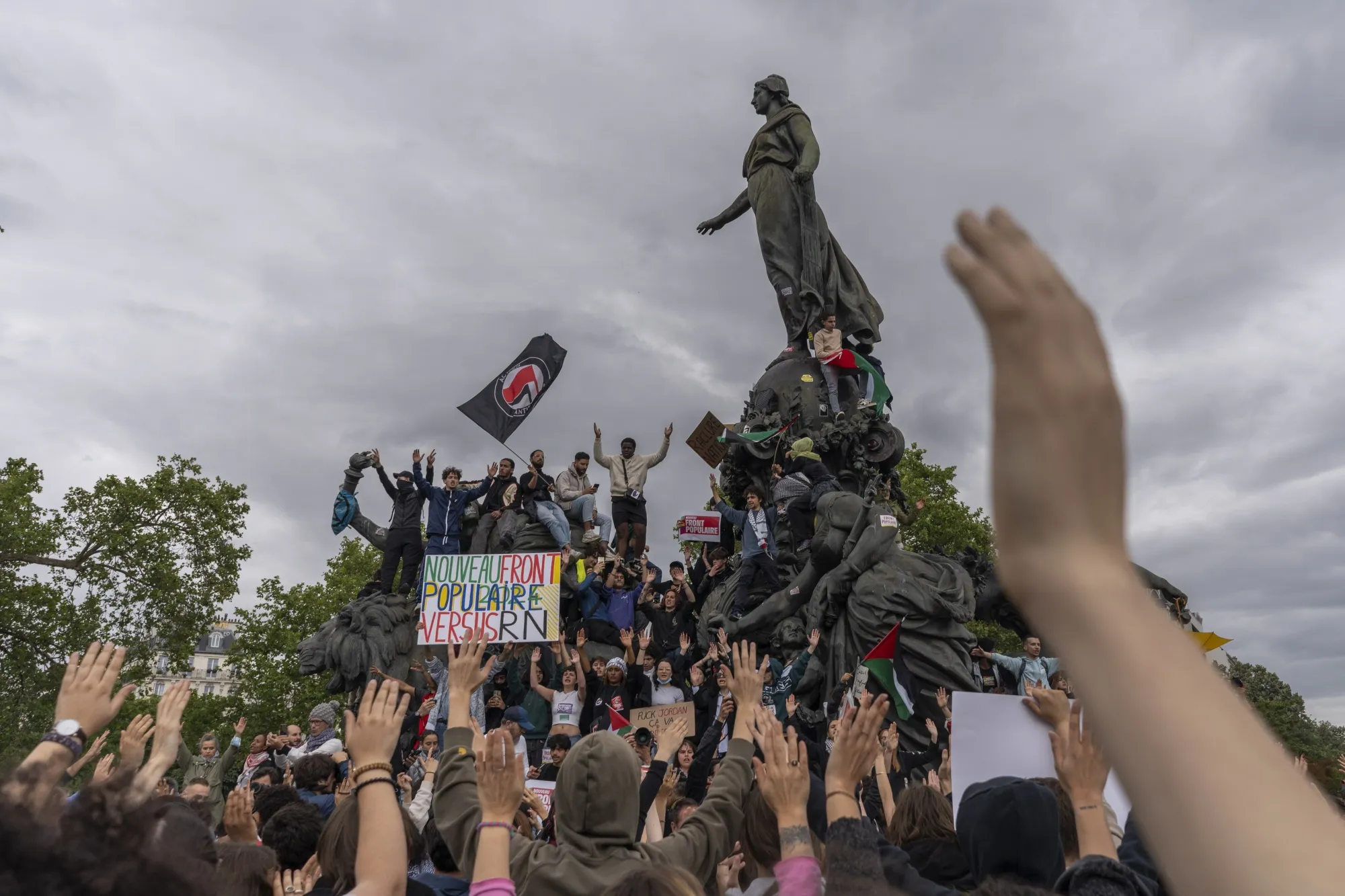 Protesters gather at Place de la Nation at the Triumph of the Republic statue during a demonstration against the far-right and racism in central Paris, France, on Saturday, June 15, 2024. Protesters took to the streets in France Saturday to oppose Marine Le Pen's far-right National Rally, which is expected to finish first in the snap legislative election President Emmanuel Macron called less than a week ago.