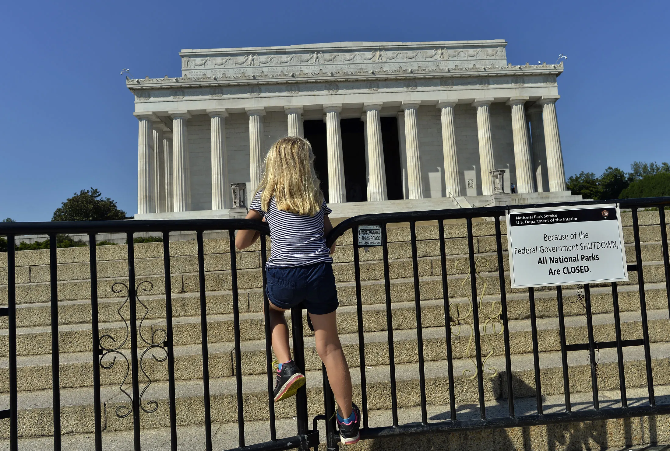 A child stands on a barricade around the Lincoln Memorial in Washington, in October 2013.
