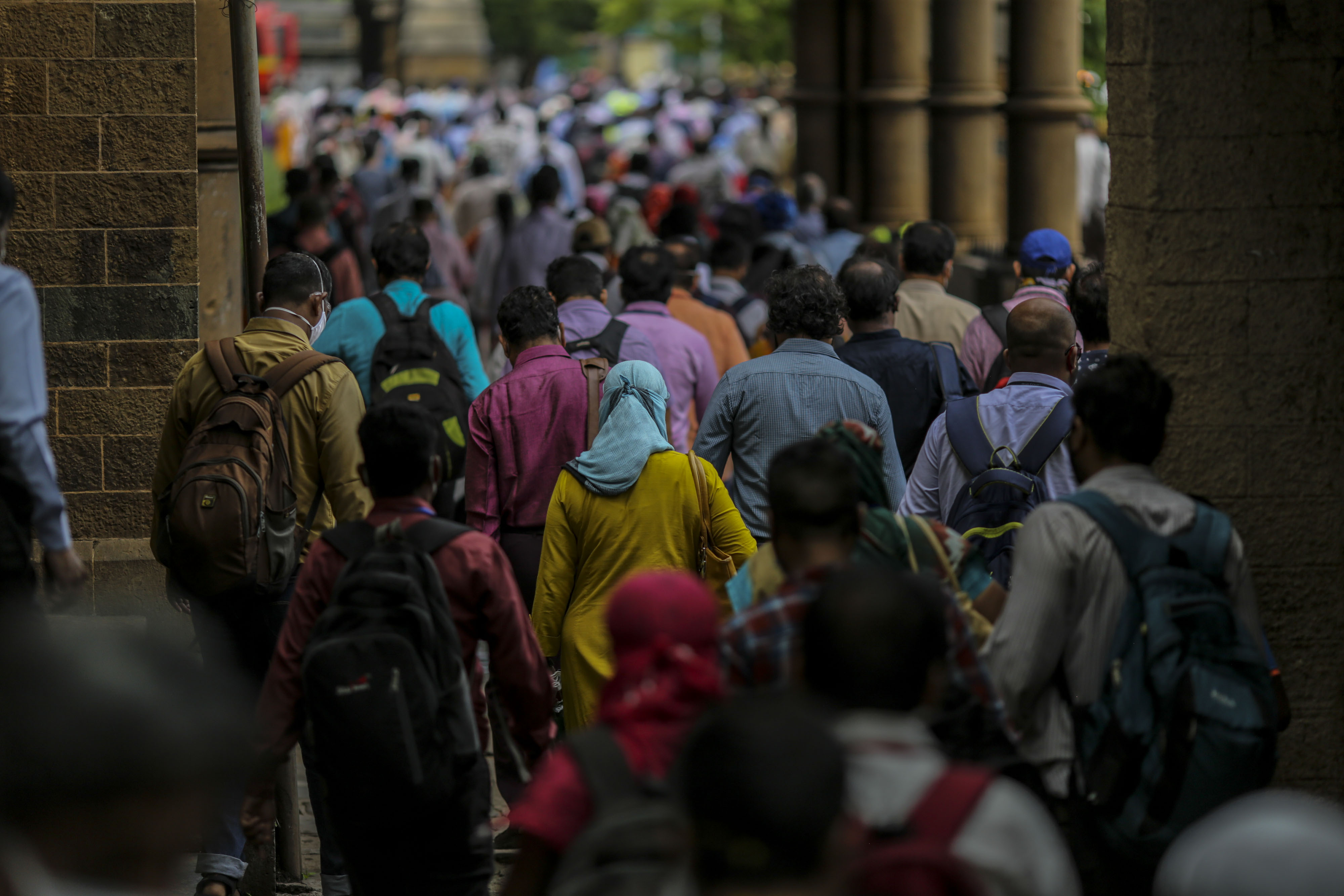 Commuters exit the Chhatrapati Shivaji Maharaj Terminus railway station in Mumbai, India.